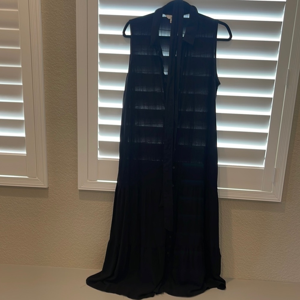 Long black sleeveless dress can be worn with or without belt